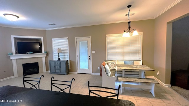 14291 Buttercup Dr, Olive Branch, MS 38654 - dining space with light tile patterned flooring, crown molding, a tile fireplace, and baseboards