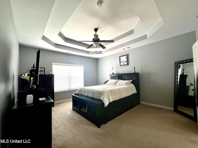 14291 Buttercup Dr, Olive Branch, MS 38654 - bedroom featuring a tray ceiling, light carpet, baseboards, and ceiling fan