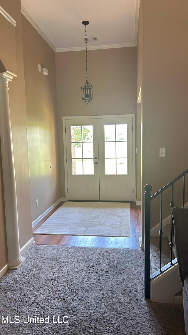 14291 Buttercup Dr, Olive Branch, MS 38654 - doorway to outside with ornate columns, ornamental molding, a towering ceiling, wood finished floors, and baseboards