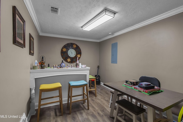 156 Cobbville Rd, Canton, MS 39046 - dining space with electric panel, wood finished floors, a textured ceiling, and crown molding