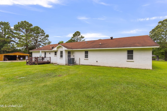 156 Cobbville Rd, Canton, MS 39046 - back of house featuring a deck, a lawn, brick siding, and a detached carport