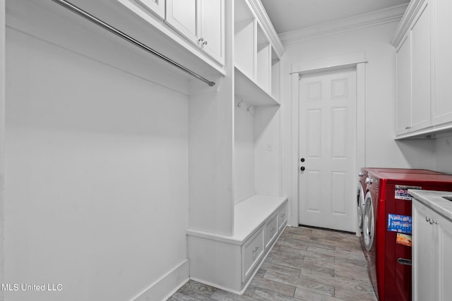 mudroom with crown molding, light hardwood / wood-style flooring, and separate washer and dryer