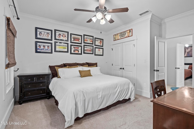 bedroom featuring a closet, ceiling fan, light carpet, and crown molding