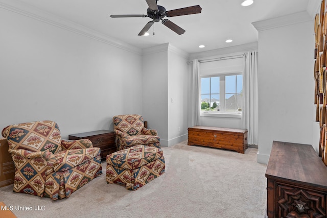 sitting room featuring crown molding, light colored carpet, and ceiling fan