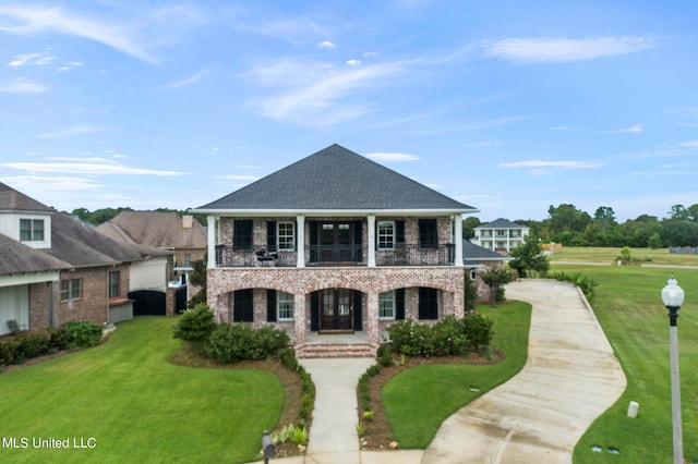 view of front of home featuring a front yard and a balcony