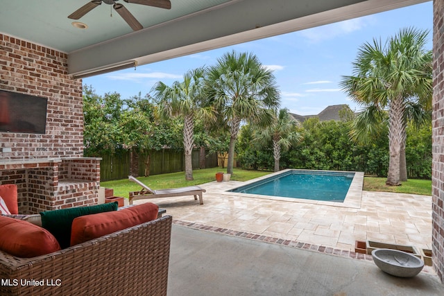 view of pool with a patio area, exterior fireplace, a lawn, and ceiling fan