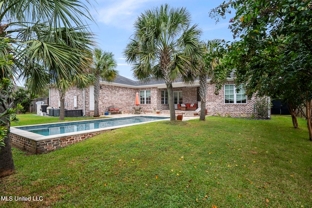 rear view of house featuring a yard and a patio area