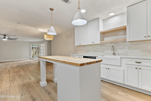 371 Lakeview Blvd, Biloxi, MS 39531 - kitchen with wooden counters, open shelves, a kitchen island, and backsplash