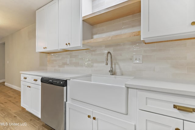 371 Lakeview Blvd, Biloxi, MS 39531 - kitchen featuring dishwasher, light wood-style floors, decorative backsplash, and white cabinets