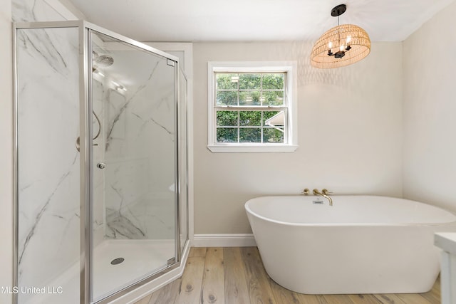 371 Lakeview Blvd, Biloxi, MS 39531 - bathroom with a freestanding bath, a marble finish shower, and wood finished floors