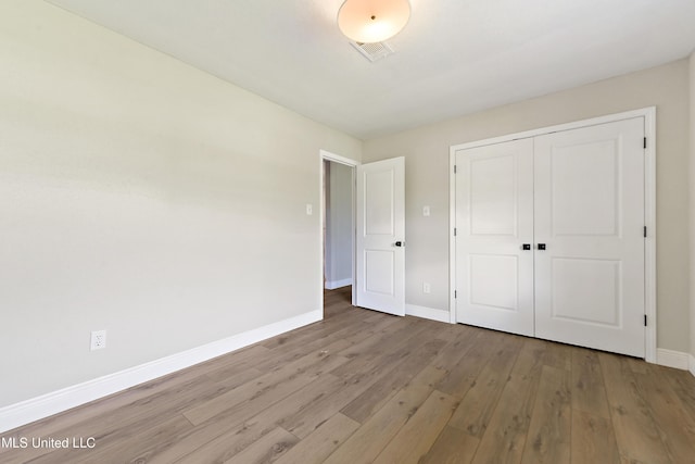 371 Lakeview Blvd, Biloxi, MS 39531 - unfurnished bedroom featuring wood finished floors and a closet
