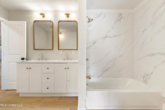 371 Lakeview Blvd, Biloxi, MS 39531 - bathroom featuring double vanity, wood finished floors, and bathtub / shower combination
