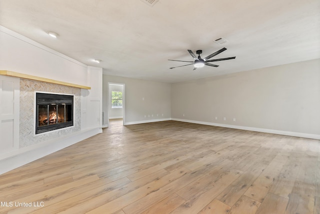 371 Lakeview Blvd, Biloxi, MS 39531 - unfurnished living room featuring light wood finished floors, ceiling fan, and a high end fireplace