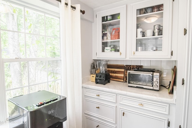 bar with a toaster and tasteful backsplash