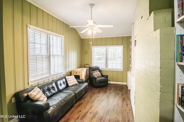 sitting room featuring a ceiling fan, ornamental molding, wood finished floors, and lofted ceiling