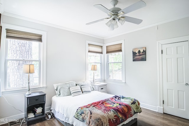bedroom with a ceiling fan, baseboards, ornamental molding, and wood finished floors