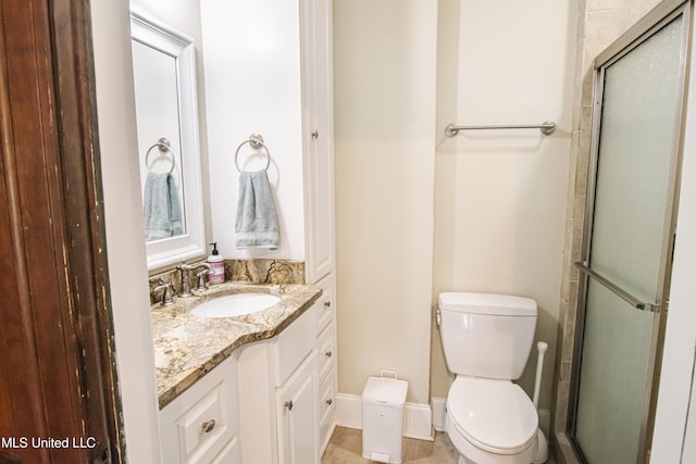 full bath featuring an enclosed shower, toilet, baseboards, and vanity