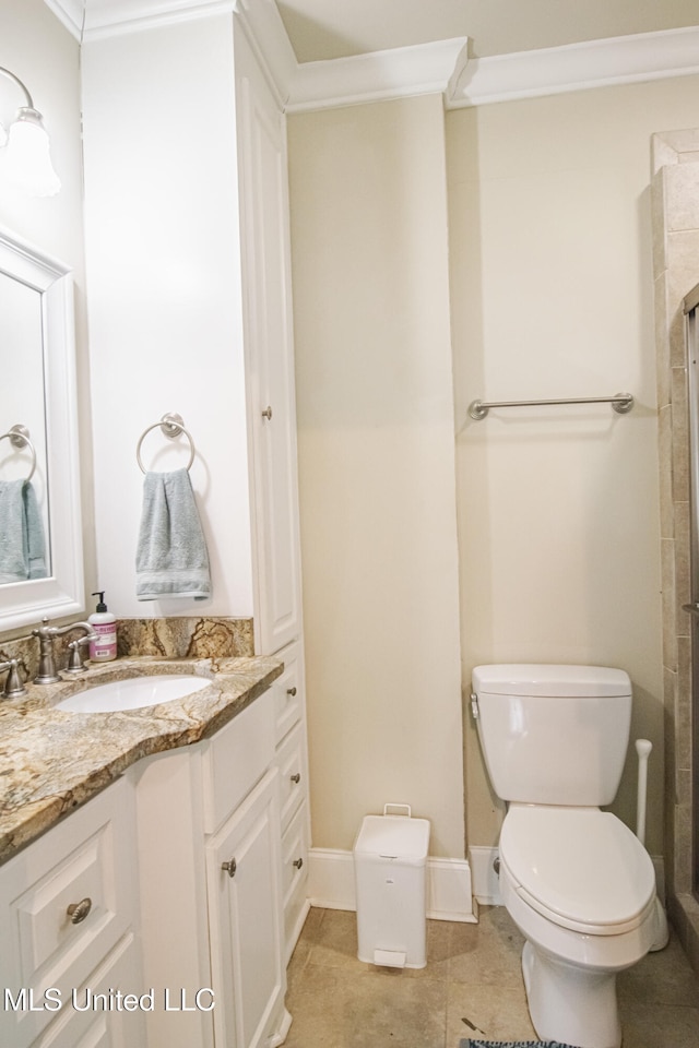 bathroom featuring crown molding, vanity, toilet, tile patterned floors, and a shower
