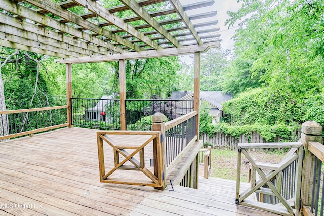 deck with a pergola and a fenced backyard