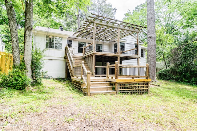 rear view of property with a yard, a wooden deck, a pergola, and stairway