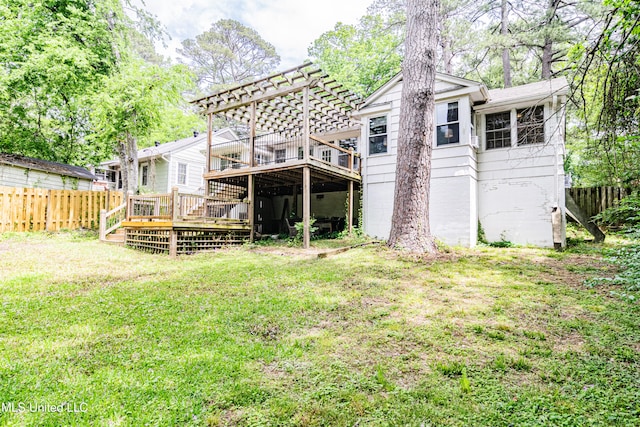 back of house featuring a yard, fence, and a wooden deck