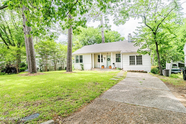 single story home featuring covered porch, a chimney, a front yard, concrete driveway, and a shingled roof