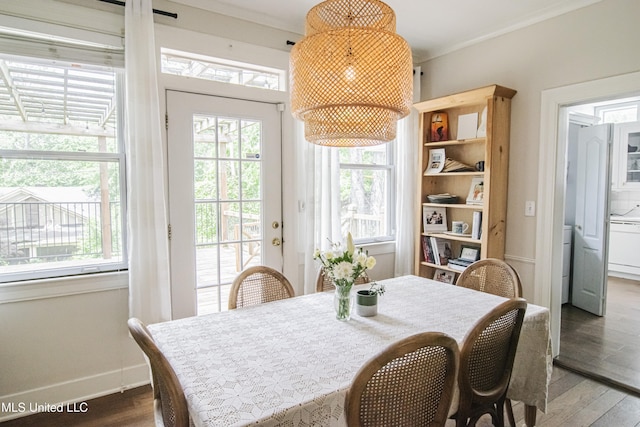 dining area with crown molding, baseboards, wood finished floors, and a wealth of natural light