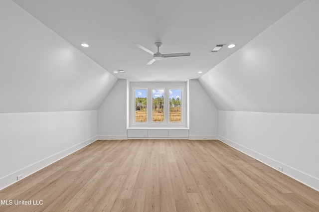 bonus room with visible vents, baseboards, ceiling fan, light wood-style flooring, and vaulted ceiling