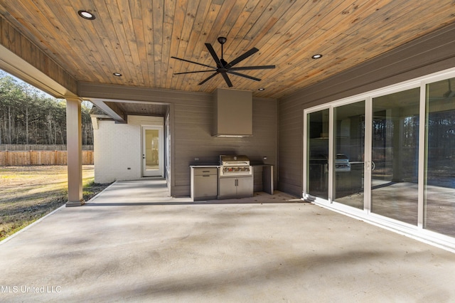 view of patio / terrace with area for grilling, fence, and a ceiling fan