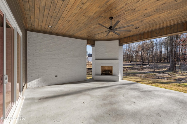 view of patio with a large fireplace and a ceiling fan