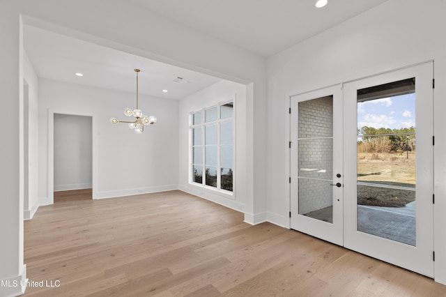 interior space with a chandelier, recessed lighting, baseboards, french doors, and light wood finished floors