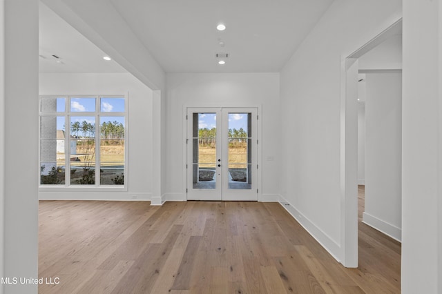 interior space with recessed lighting, light wood-style flooring, baseboards, and french doors