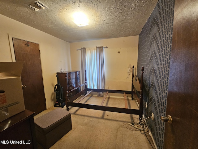 bedroom featuring visible vents and a textured ceiling