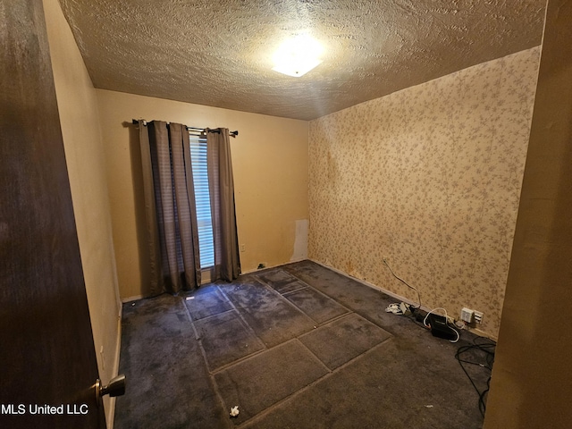 spare room featuring a textured ceiling