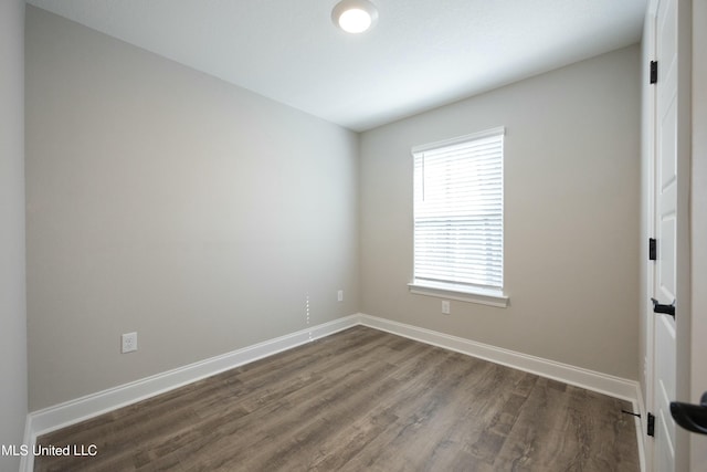 empty room with dark wood-type flooring