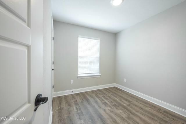 empty room with hardwood / wood-style flooring