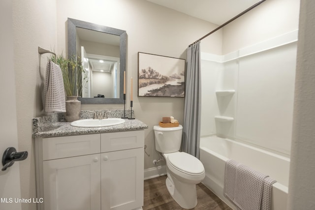 full bathroom with hardwood / wood-style flooring, vanity, toilet, and shower / tub combo