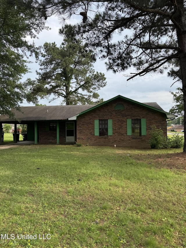 single story home featuring an attached carport and a front lawn