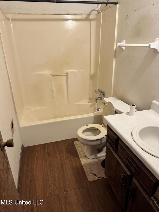 full bath with wood finished floors, toilet, bathtub / shower combination, and vanity
