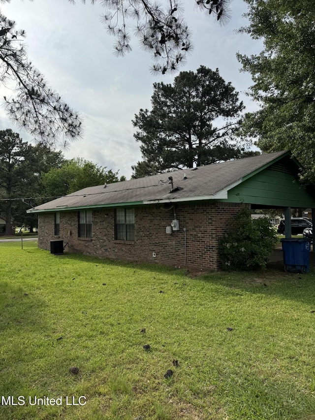 back of house with a yard and central air condition unit