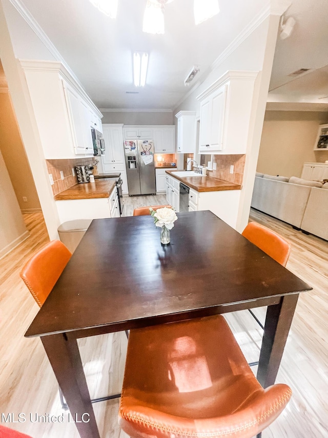 420 Stoneybrook Dr, Brandon, MS 39042 - dining area with light wood finished floors and crown molding