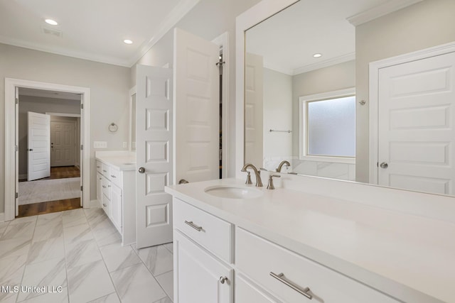 full bath with marble finish floor, crown molding, recessed lighting, two vanities, and a sink