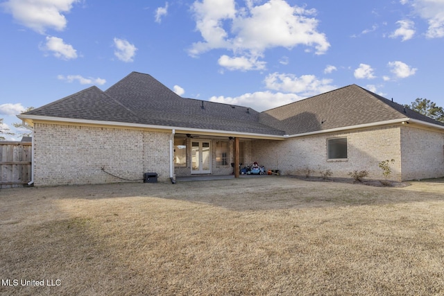 back of house with brick siding, roof with shingles, a patio area, and a ceiling fan