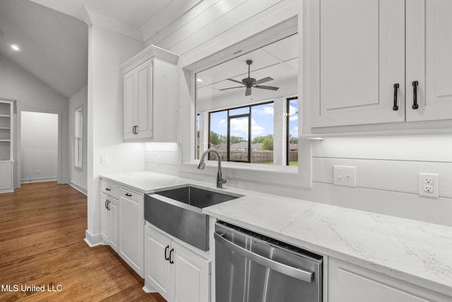 kitchen with stainless steel dishwasher, white cabinetry, a ceiling fan, wood finished floors, and a sink
