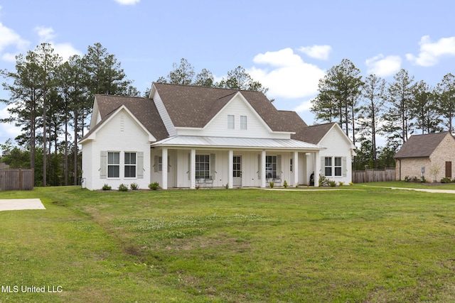 view of front facade featuring a front yard, fence, and board and batten siding