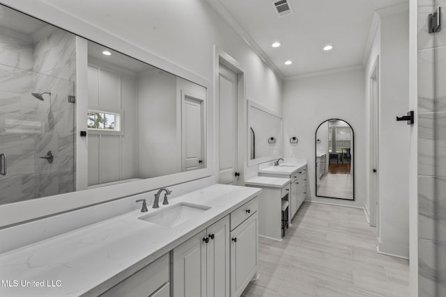 full bathroom featuring ornamental molding, visible vents, recessed lighting, a sink, and a stall shower