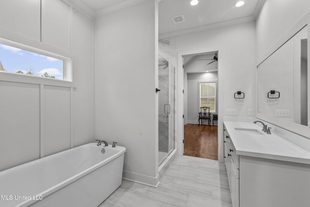 bathroom featuring visible vents, a ceiling fan, a soaking tub, a shower stall, and vanity