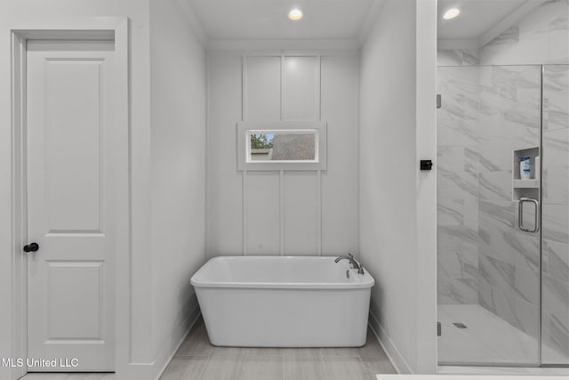 full bathroom featuring baseboards, a freestanding bath, crown molding, recessed lighting, and a marble finish shower