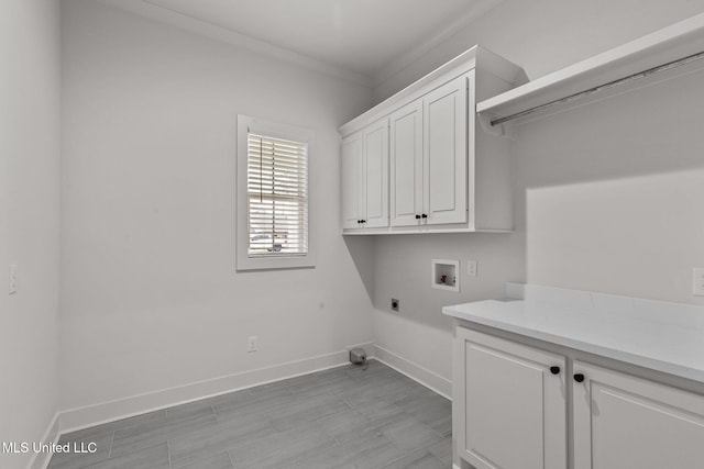 laundry room featuring cabinet space, baseboards, electric dryer hookup, and washer hookup