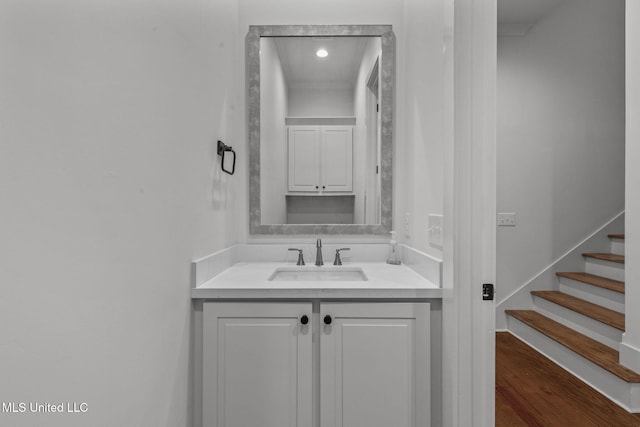 bathroom with wood finished floors and vanity